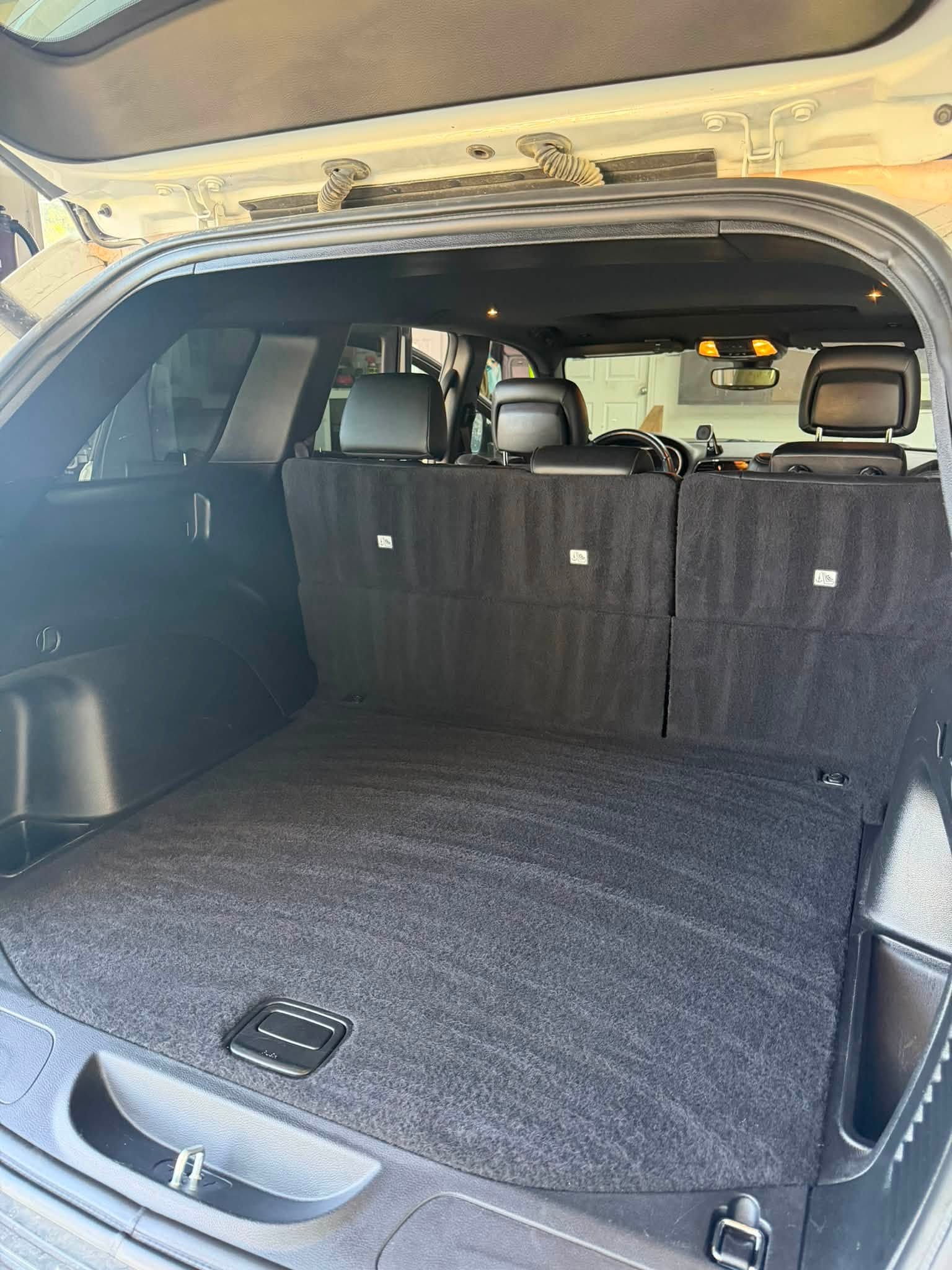 Jeep cargo area after detailing with clean carpet and trim