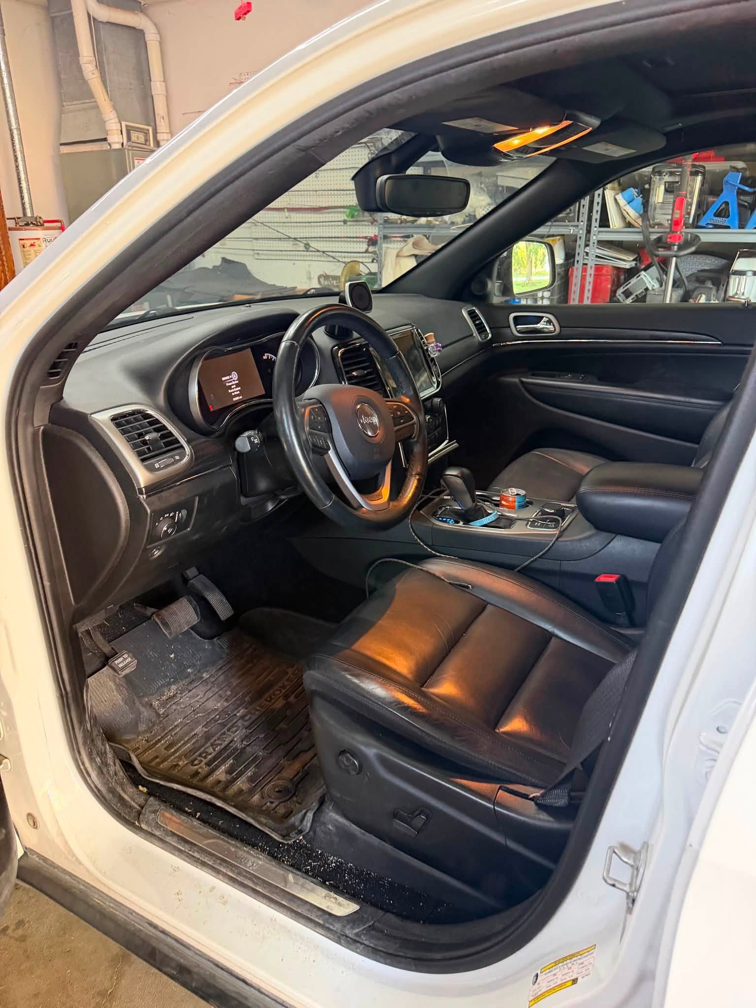 Jeep front cabin before detailing with dirt on the floor mat and door sill
