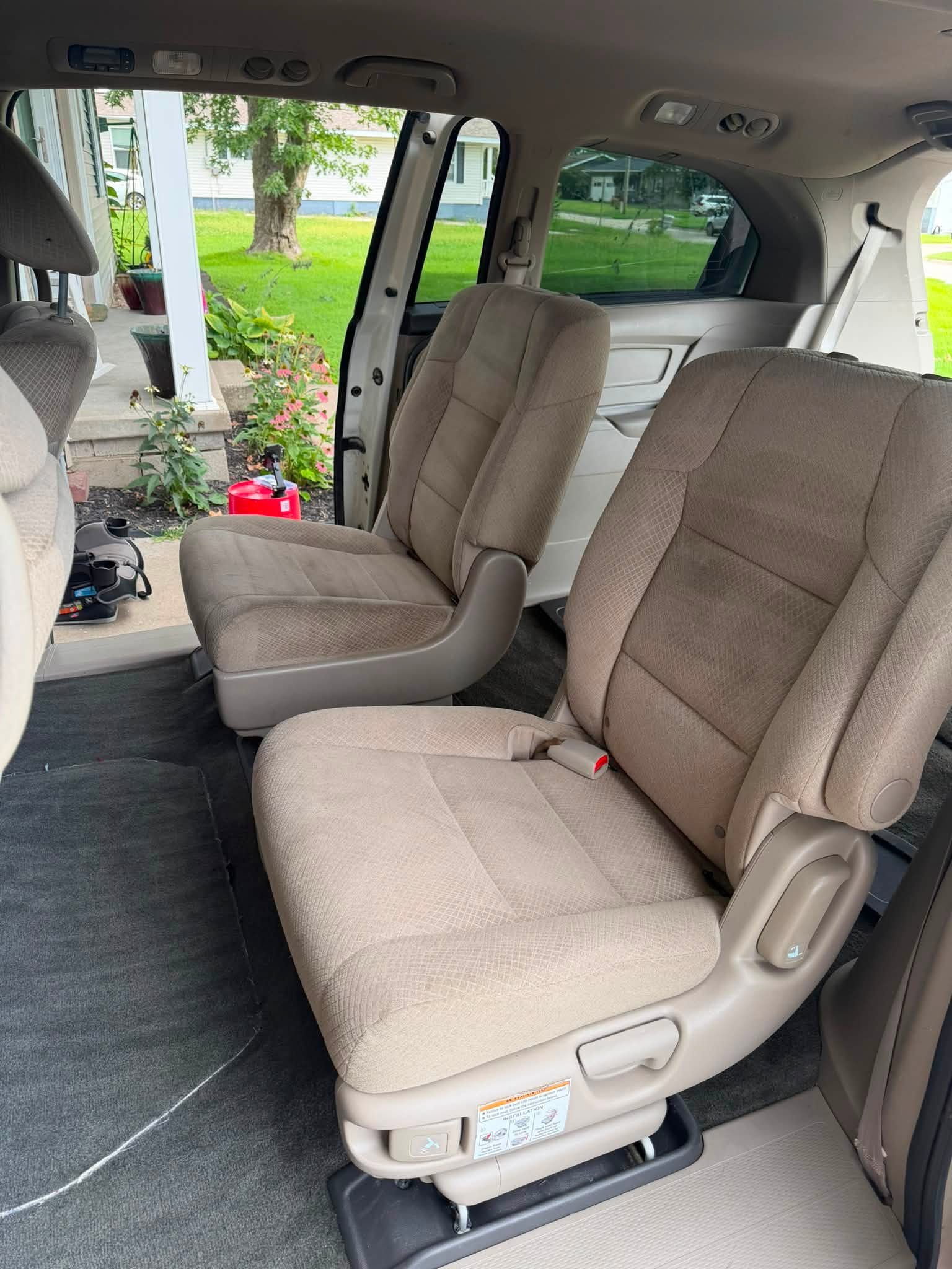 Minivan passenger area after detailing with clean seating, carpet and interior trim