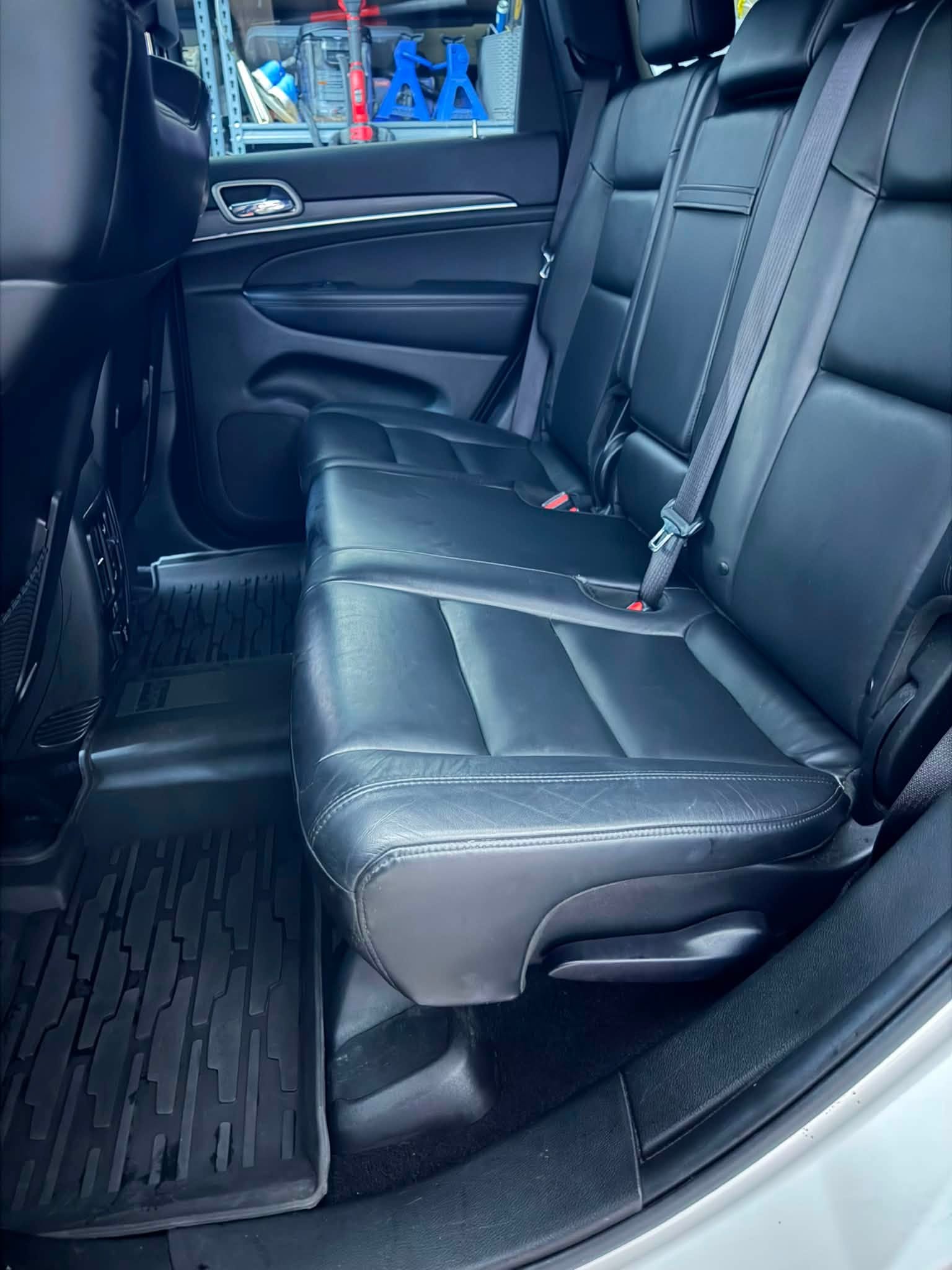 Jeep rear seating area after detailing with clean leather and floor mats