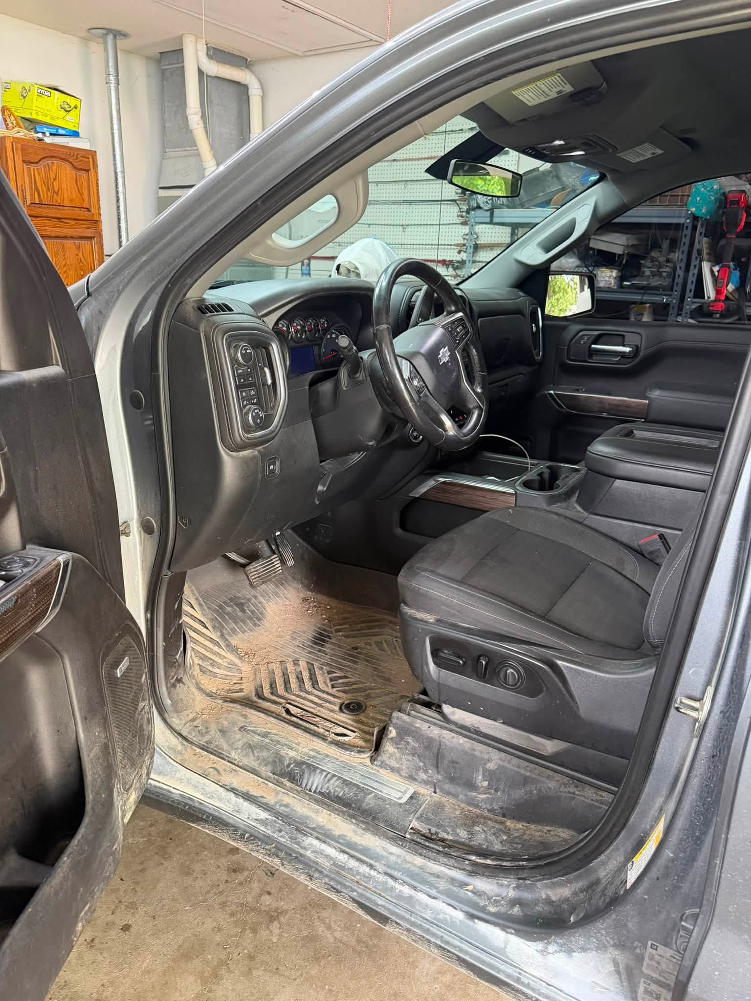 Truck driver area before detailing with heavy dirt across the floor mat and door sill