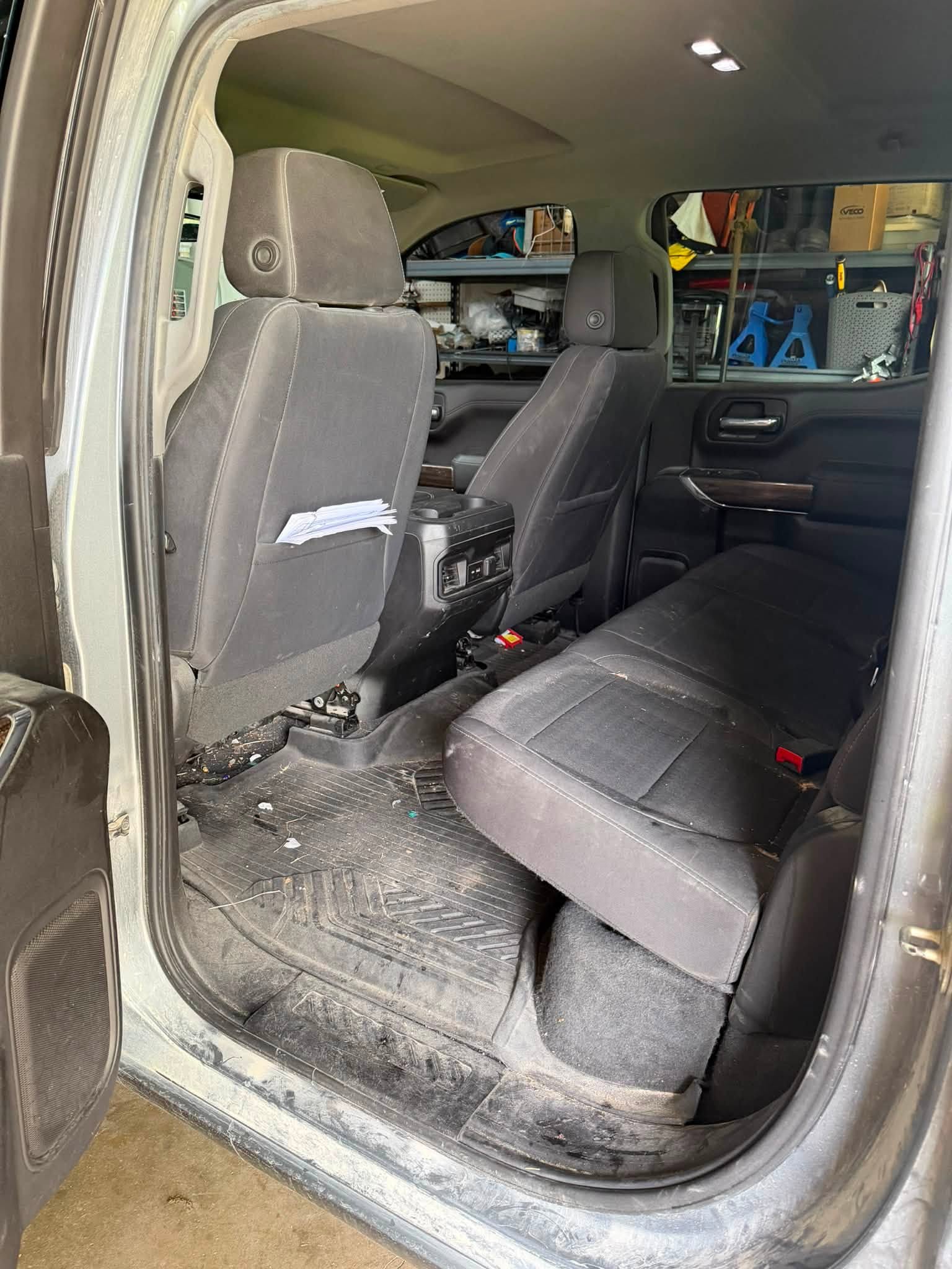 Truck rear cabin before detailing with dirt and debris across the floor and seats
